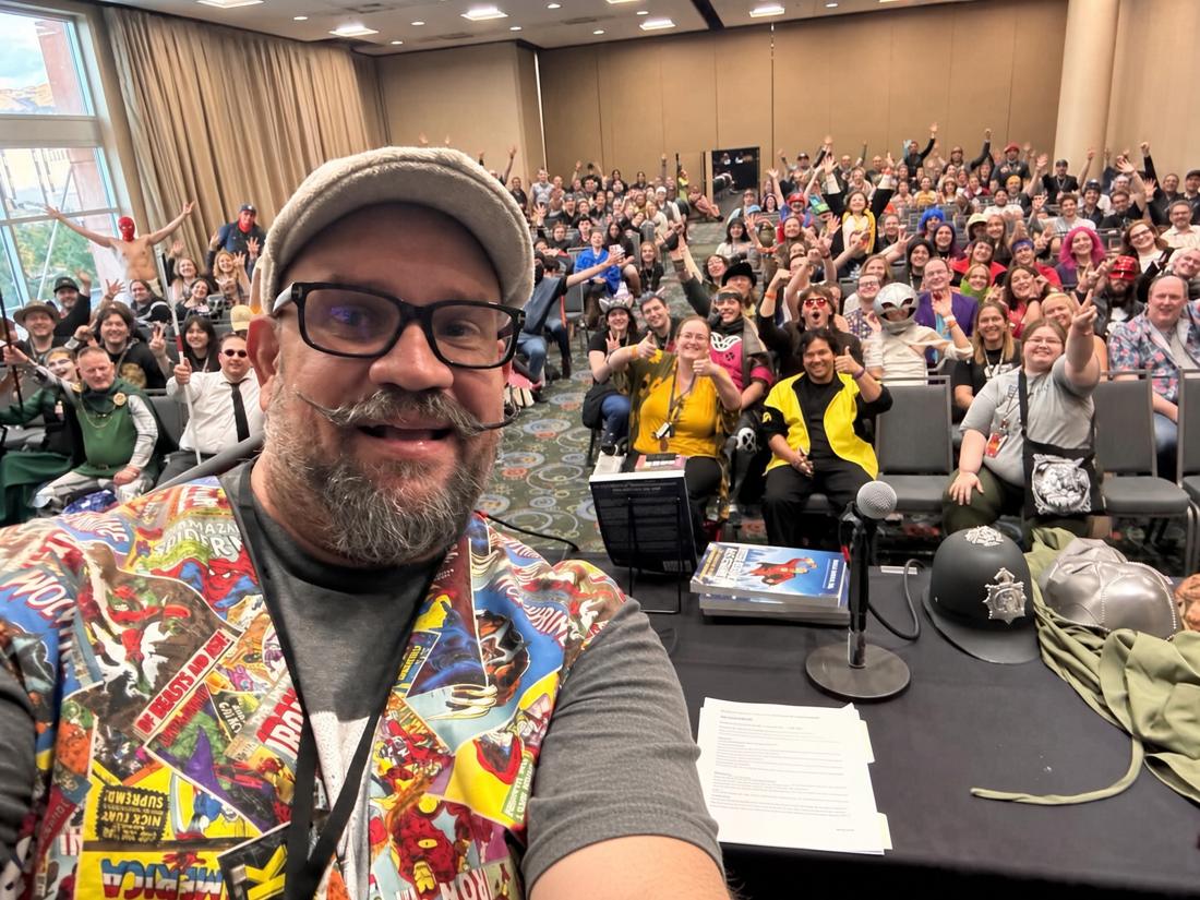 Brian taking a selfie in front of a packed, cheering FanX Salt Lake City panel audience