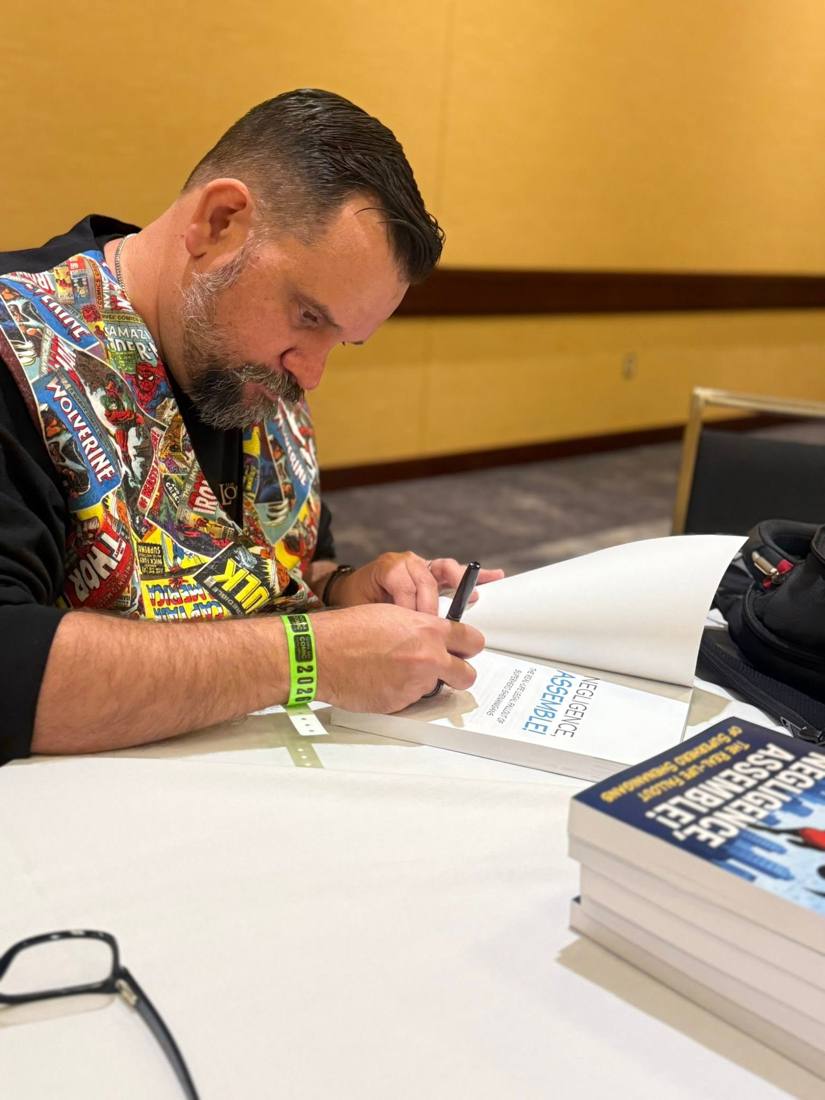 Brian signing a copy of his book